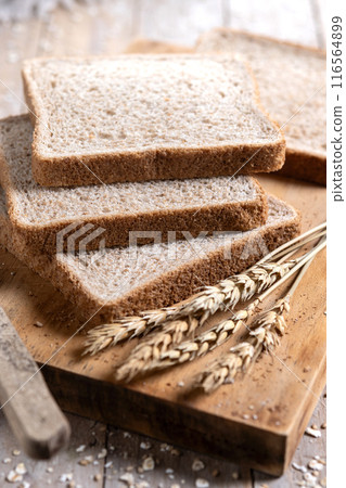 Healthy wholemeal bread slices on rustic wooden table. Healthy wholemeal bread slices on rustic wooden table. 116564899