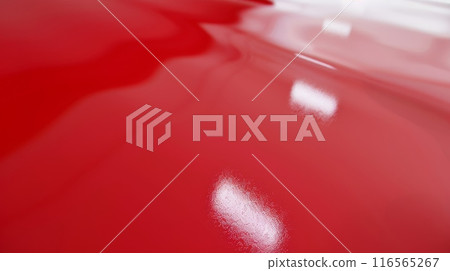 Shiny Red Plastic Surface with Light Reflections, Ideal for Backgrounds and Textures 116565267