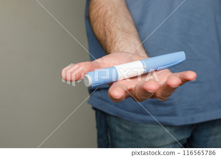 Semaglutide Injection Diabetes Drug Being Used For Weight Loss in male hand closeup Semaglutide Injection Diabetes Drug Being Used For Weight Loss in male hand closeup 116565786