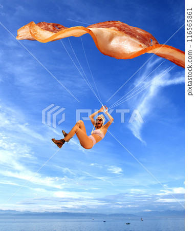 Poster. Contemporary art collage. Surreal artwork. Blending reality and fantasy. Woman paragliding with slice of bacon as her parachute. 116565861