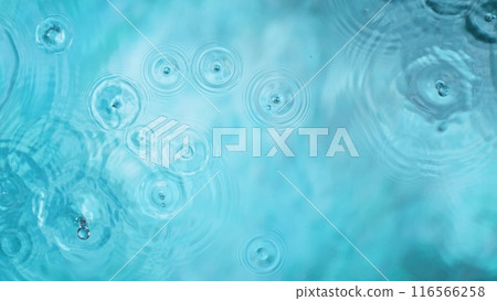 Freeze motion of splashing water drops on on light blue background Freeze motion of splashing water drops on on light blue background 116566258
