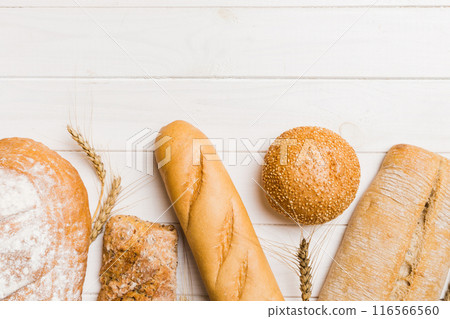 Homemade natural breads. Different kinds of fresh bread as background, top view with copy space Homemade natural breads. Different kinds of fresh bread as background, top view with copy space 116566560