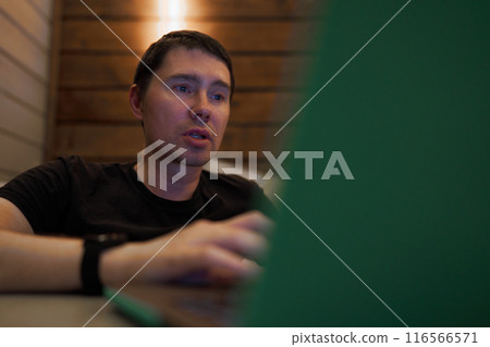 Man Engaged in Late-Night Work on Laptop Man Engaged in Late-Night Work on Laptop 116566571