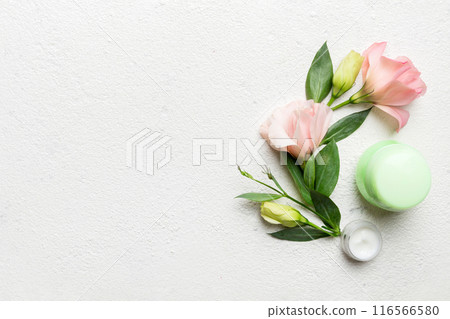 Composition with cosmetic products and beautiful roses on cement background. Copy space, flat lay Composition with cosmetic products and beautiful roses on cement background. Copy space, flat lay 116566580