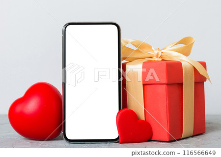 mobile phone with blank screen on colored background with hearts, calendar and gift box, valentine day concept perspertive view flat lay mobile phone with blank screen on colored background with hearts, calendar and gift box, valentine day concept perspertive view flat lay 116566649