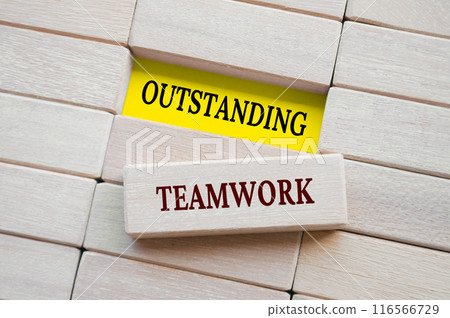 Top view of Outstanding Teamwork text on wooden blocks. Teamwork concept. Top view of Outstanding Teamwork text on wooden blocks. Teamwork concept. 116566729