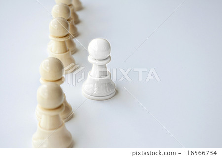 White shining pawn stepping out from the rest of the soldier pawn. Leadership concept. 116566734