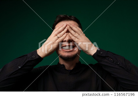 Man Covering His Eyes With His Hands 116567196