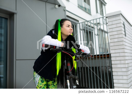 Woman With Green Hair Riding a Bike 116567222
