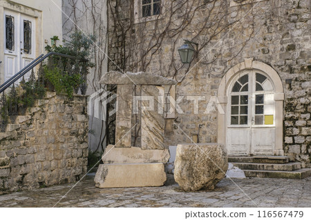 Rustic Stone Courtyard, Ancient Stone Building with Arched Doorway in Old Town Rustic Stone Courtyard, Ancient Stone Building with Arched Doorway in Old Town 116567479