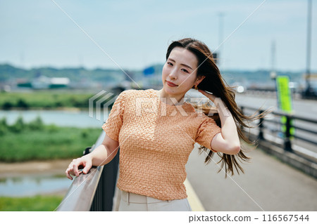 A young woman with long hair brushing her hair A young woman with long hair brushing her hair 116567544