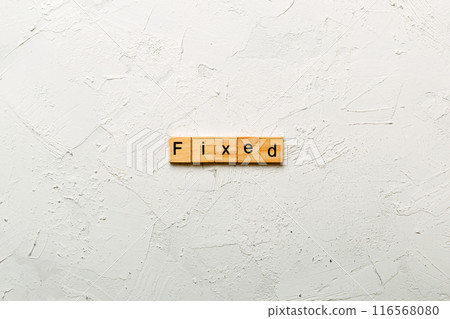 fixed word written on wood block. fixed text on table, concept fixed word written on wood block. fixed text on table, concept 116568080