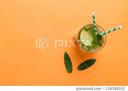 Caipirinha, Mojito cocktail, vodka or soda drink with lime, mint and straw on table background. Refreshing beverage with mint and lime in glass top view flat lay Caipirinha, Mojito cocktail, vodka or soda drink with lime, mint and straw on table background. Refreshing beverage with mint and lime in glass top view flat lay 116568102
