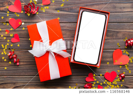 Opened gift box with ribbon and phone on color background, top view. Blank open box packaging mockup , Template for your design - branding mockup Opened gift box with ribbon and phone on color background, top view. Blank open box packaging mockup , Template for your design - branding mockup 116568146