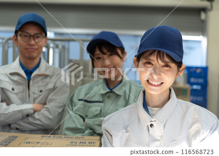 Three men and women working in a warehouse Three men and women working in a warehouse 116568723