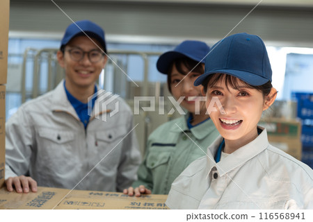 Three men and women working in a warehouse Three men and women working in a warehouse 116568941