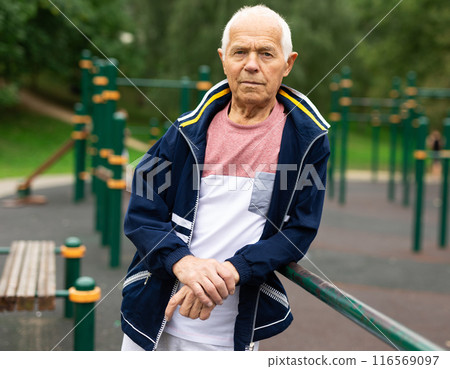 Portrait of sporty grandfather on playground in summer park 116569097