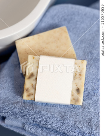 Soap bar with blank label on blue towels near vessel sink in bathroom closeup, mockup Soap bar with blank label on blue towels near vessel sink in bathroom closeup, mockup 116570659