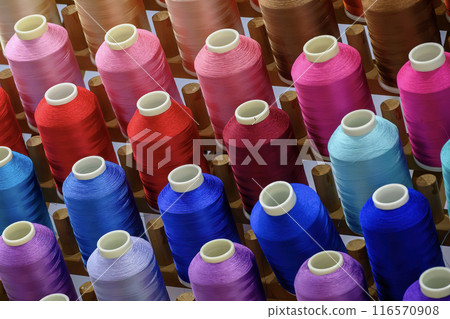 Close up the multi-color group of industry bobbin thread. Close up the multi-color group of industry bobbin thread. 116570908