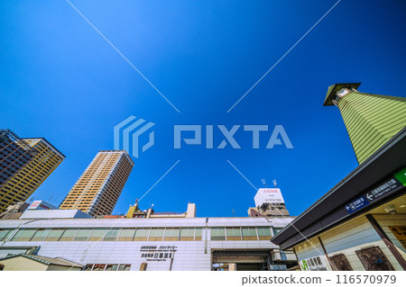 Tokyo cityscape in July. View of JR Nippori Station South ticket gate (right) and Keisei Electric Railway Nippori Station (5th) 116570979