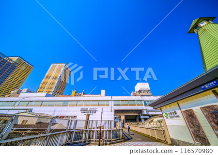 Tokyo cityscape in July. View of JR Nippori Station South ticket gate (right) and Keisei Electric Railway Nippori Station (5th) 116570980