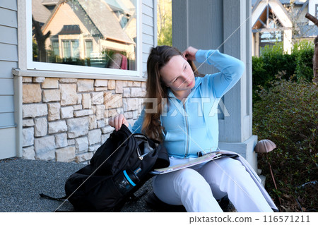 Young girl student smiling near university. Cute girl student holds books. Learning, education concept 116571211