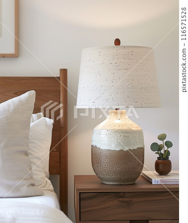 Handmade ceramic table lamp using glazed pottery material. Lampshade is made of fabric. 116571528