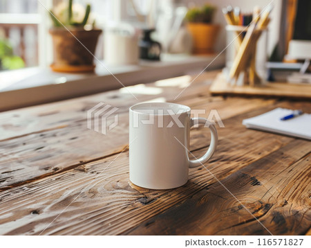 A white mug sitting on a vintage aged rosewood desk with various modern office supplies organized around it.  A white mug sitting on a vintage aged rosewood desk with various modern office supplies organized around it.  116571827