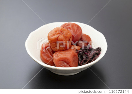 Pickled plums on a black background Pickled plums on a black background 116572144