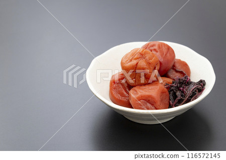 Pickled plums on a black background Pickled plums on a black background 116572145