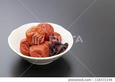 Pickled plums on a black background Pickled plums on a black background 116572146