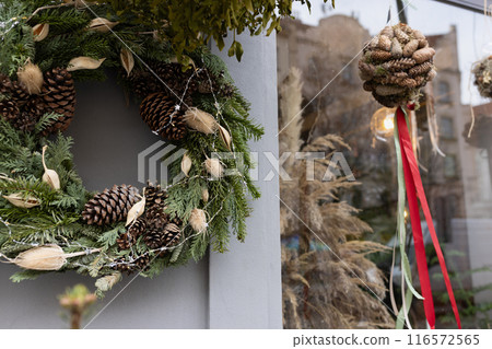 Festive Christmas Holiday Wreath and Decorations on Elegant Outdoor Display 116572565