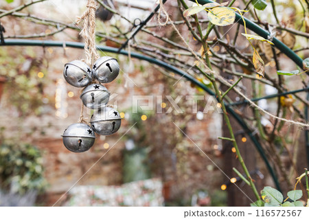 Christmas Silver Bells Hanging in a Rustic Garden. 116572567
