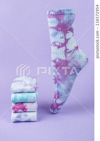 Tie dye colorful socks on purple background. volumetric sock and stack of different Tie dye socks. Tie dye colorful socks on purple background. volumetric sock and stack of different Tie dye socks. 116572954