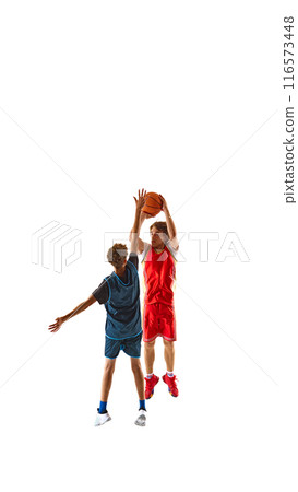 Basketball player in blue taking precise shot, while his opponent in red leaps to block, against white studio background, emphasizing sport's competitive spirit. Basketball player in blue taking precise shot, while his opponent in red leaps to block, against white studio background, emphasizing sport's competitive spirit. 116573448