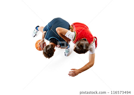 High-energy moment in basketball game as two players vie for control of ball against white studio background. Dribbling. Aerial view. 116573494