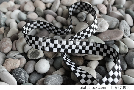 Loops Of Fabric Racing Checkered Stripe On Decorative Rocks Stock Photo For Racing Sports Backgrounds 116573903