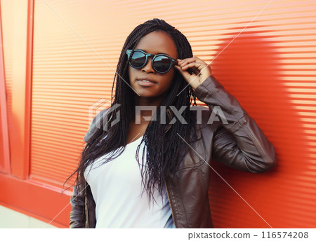 Fashionable young African woman in casual clothing, stylish modern black girl posing in the city Fashionable young African woman in casual clothing, stylish modern black girl posing in the city 116574208