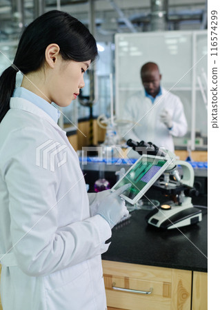 Scientist studying new virus or strain Scientist studying new virus or strain 116574299