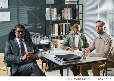 Several intercultural lawyers by desk 116574386