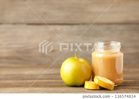 Jar of baby puree with apple and banana on grey background 116574814