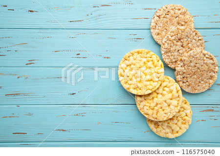Various types of healthy whole grain crispbreads on blue wooden background. Corn and buckwheat crispbread 116575040