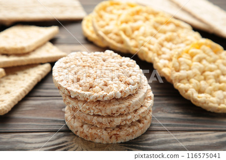 Various types of healthy whole grain crispbreads on brown wooden background. Various types of healthy whole grain crispbreads on brown wooden background. 116575041