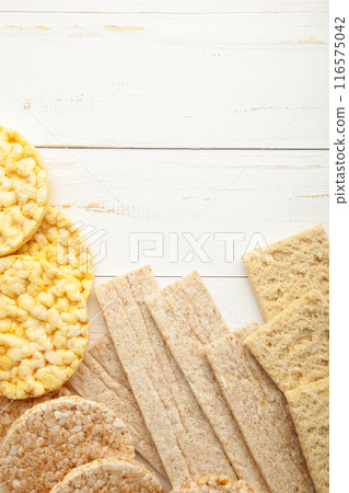 Various types of healthy whole grain crispbreads on white wooden background. Vertical foto 116575042