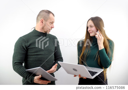 Team of diverse partners sitting at table mature Latin business man and European business woman discussing project on laptop in office. Two colleagues of professional business people working together. Team of diverse partners sitting at table mature Latin business man and European business woman discussing project on laptop in office. Two colleagues of professional business people working together. 116575086