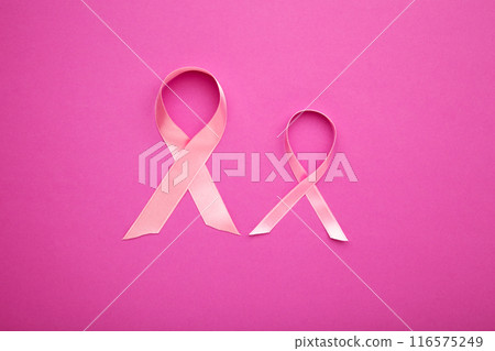Pink satin breast cancer awareness ribbons on pink Pink satin breast cancer awareness ribbons on pink 116575249