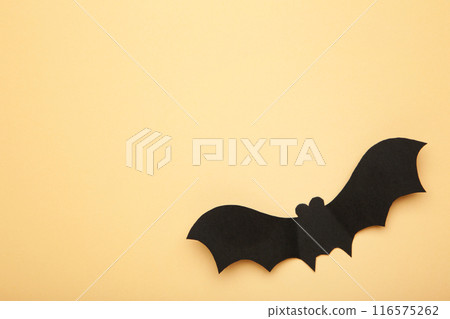 Halloween paper bat on biege background. Halloween concept. Halloween paper bat on biege background. Halloween concept. 116575262