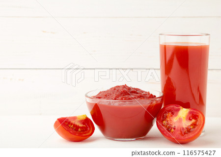 Fresh tomatoes with paste and juice on white background 116575427