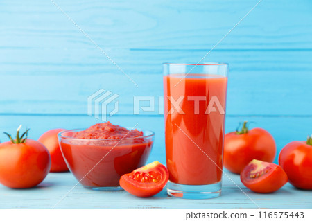 Fresh tomatoes with paste and juice on blue background 116575443