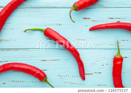 Red hot chili peppers on blue background with copy space Red hot chili peppers on blue background with copy space 116575537